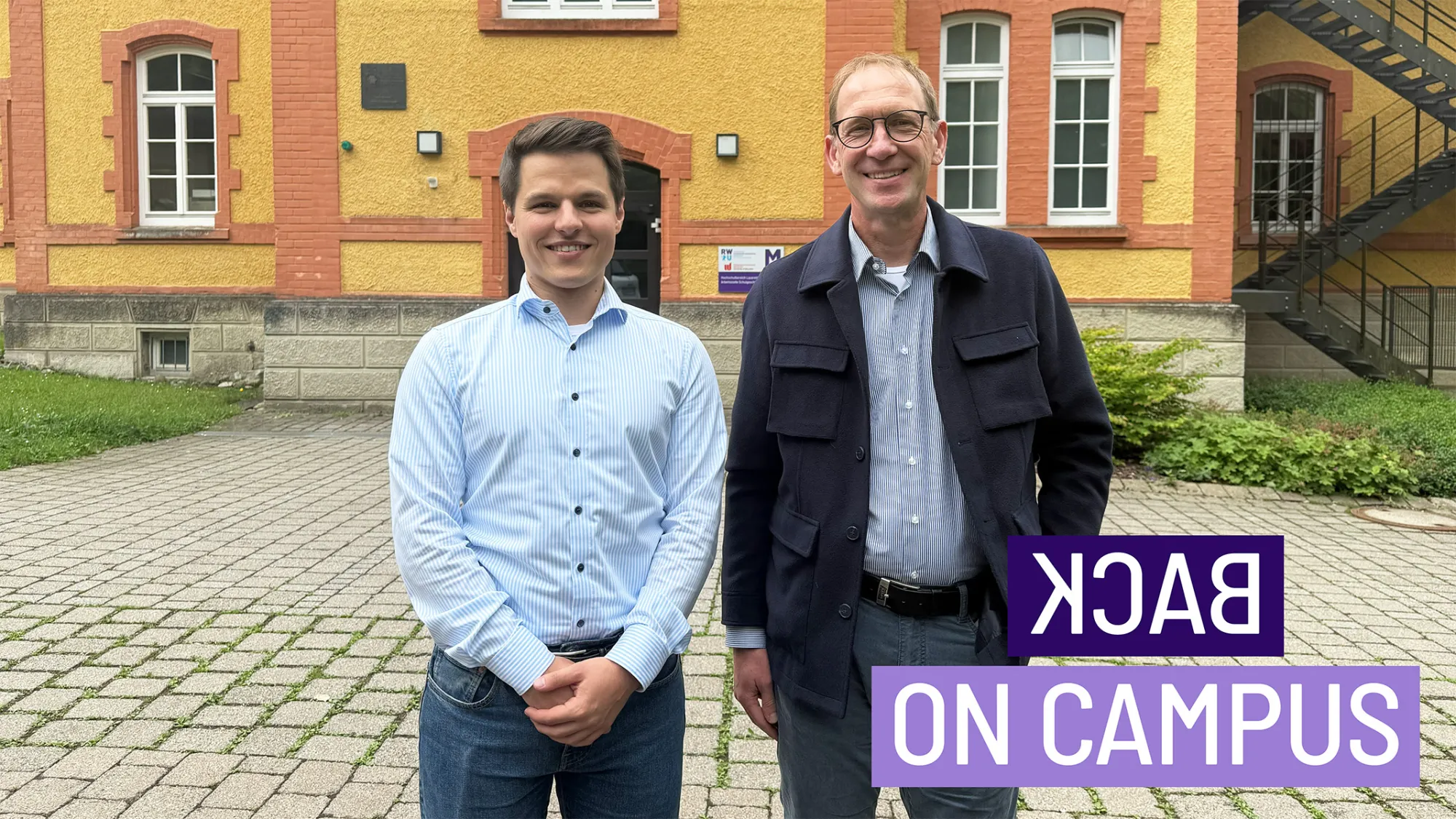RWU-Alumnus Marc Stocker und Professor Dr. Jürgen Friedl vor dem M-Gebäude der RWU Hochschule Ravensburg-Weingarten