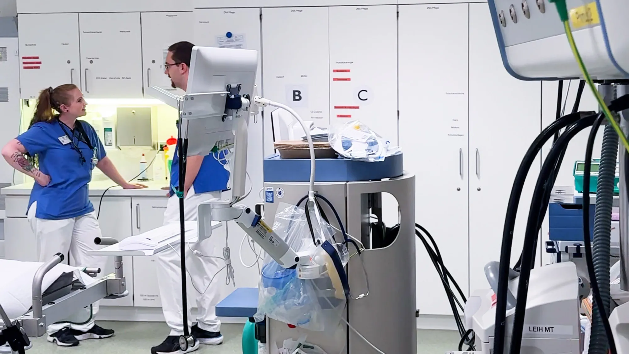 Zwei Physician Assistants in einem Klinikraum im Gespräch