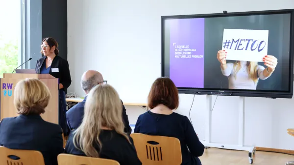 Professorin Dr. Monika Schröttle bei der Euregio-Ringtagung 2025 und einem Bildschirm mit MeToo am Bildschirm. 
