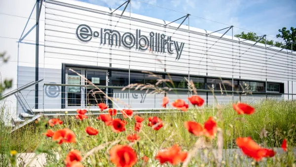 Außenansicht des E-Mobility Labors der RWU mit Blumenwiese im Vordergrund