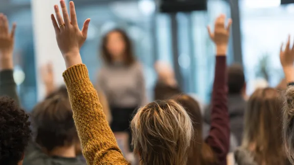 Mehrere Menschen melden sich während eines Vortrags 