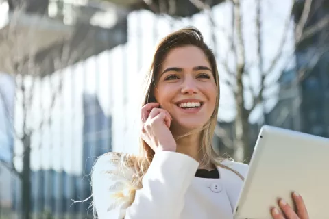 Frau telefoniert mit Tablet in der Hand